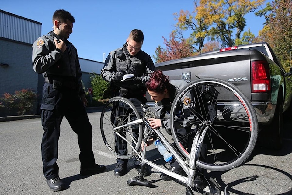 Police officer checking bike serial number